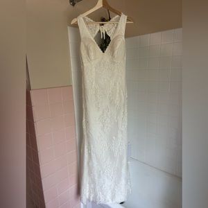 Open back, lace wedding dress size 12. Only worn for ceremony (approx 3 hours)